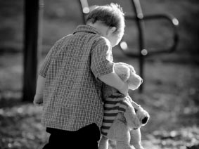 sad child wandering through a playground